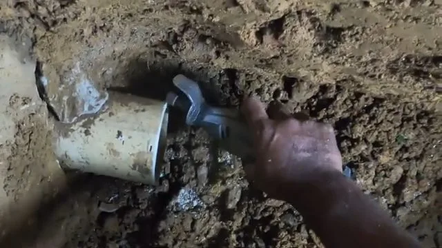 Cutting damaged sewer pipe in excavation, on a Rockwall County job